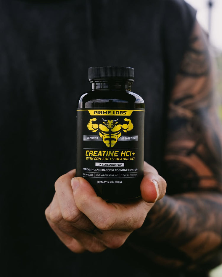 Tattooed hand holding a Prime Labs Creatine HCl+ bottle with CON-CRET creatine HCl label — is a creatine loading phase necessary